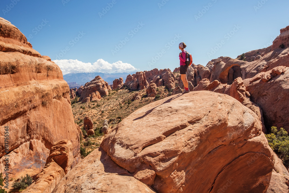 Hiker rests in Arches National park in Utah, USA Hiker rests in Arches National park in Utah, USA