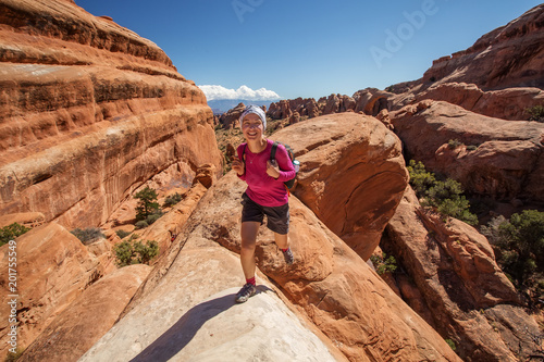 Hiker rests in Arches National park in Utah, USA