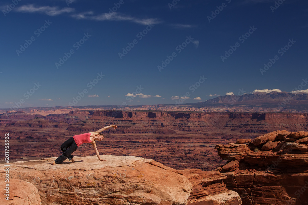 Woman meditating doing yoga in Canyonlands National park in Utah, USA