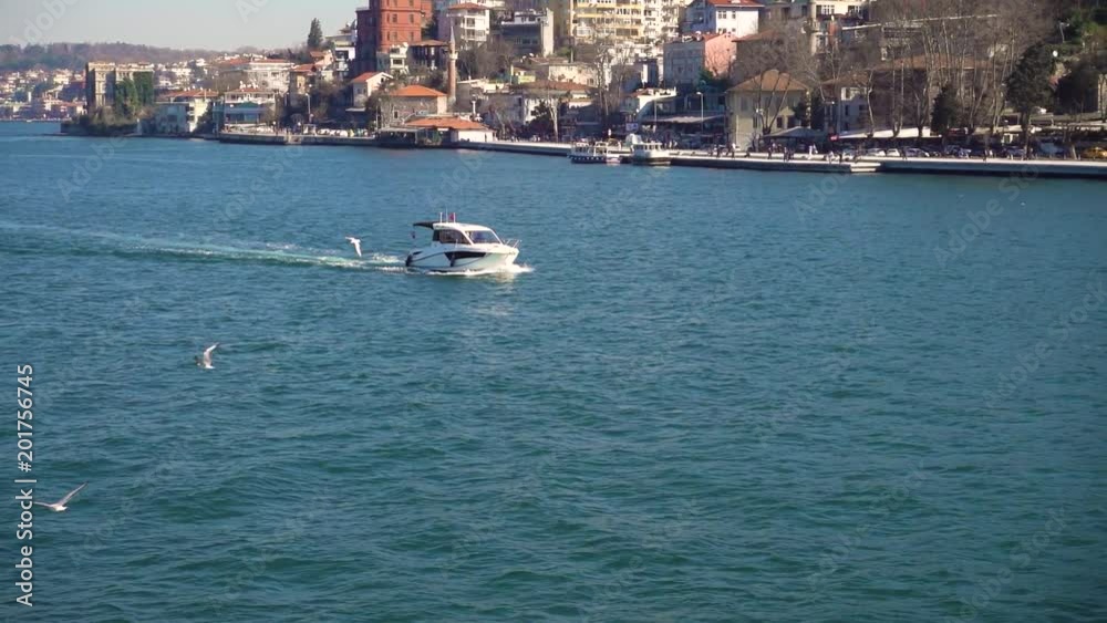 Slow motion video. Sailing along the shore of Bosphorus on a small motor yacht. Slow motion video. Sailing along the shore of Bosphorus on a small motor yacht.