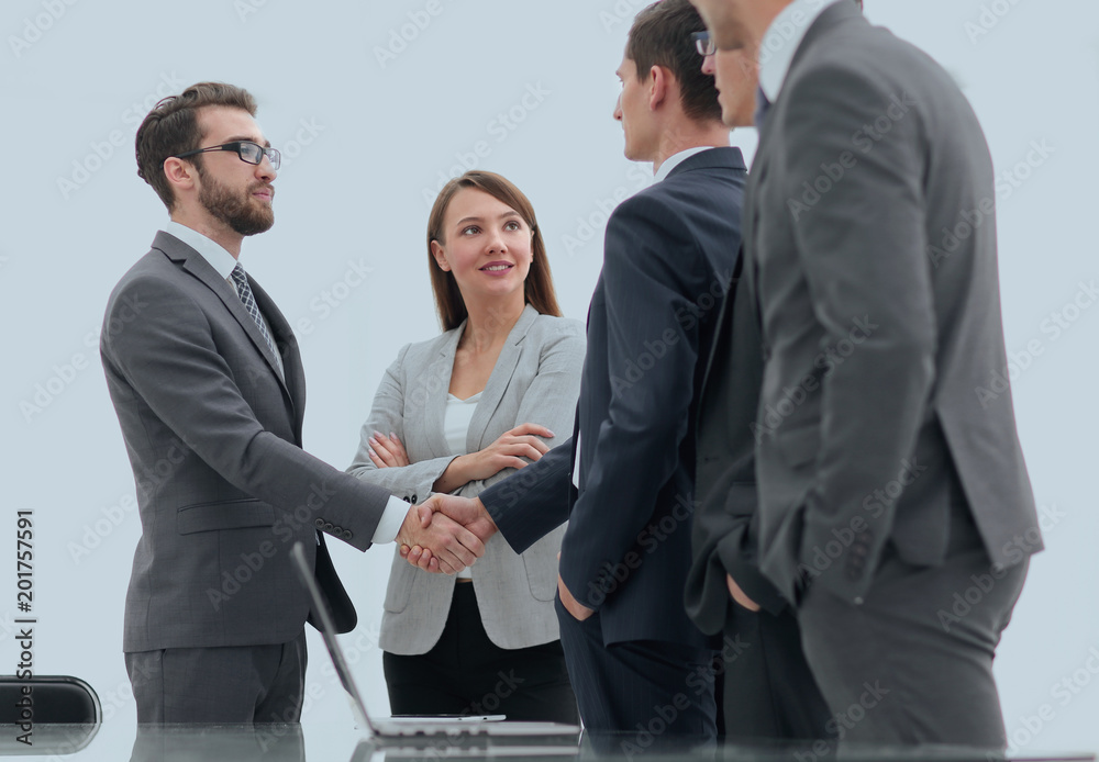 Successful business people shaking hands in an office. Successful business people shaking hands in an office.