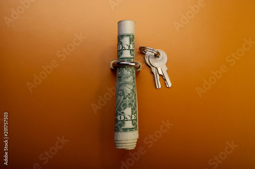 folded American one dollar bill in a padlock and keys. photo