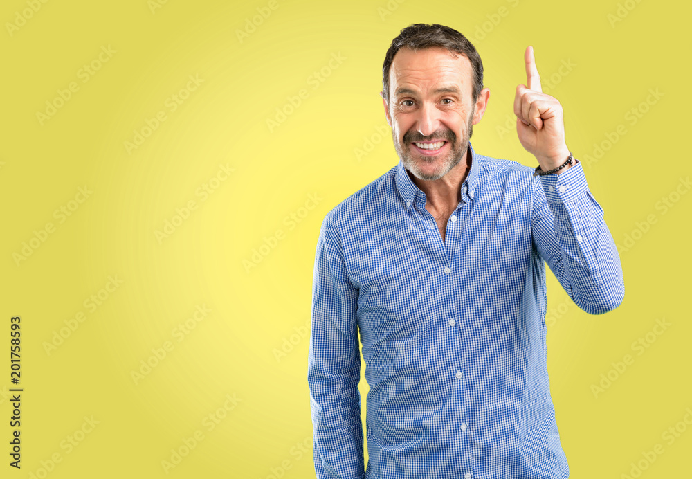 Handsome middle age man happy and surprised cheering expressing wow gesture pointing up Handsome middle age man happy and surprised cheering expressing wow gesture pointing up