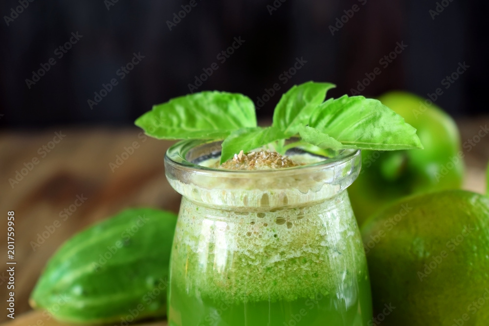 Green smoothie in a glass jar sprinkled with brans decorated with basil Green smoothie in a glass jar sprinkled with brans decorated with basil