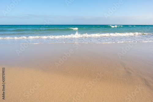closeup of sand on beach and blue summer sky