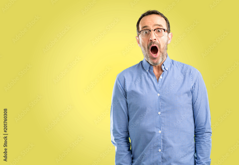 Handsome middle age man scared and surprised cheering expressing wow gesture. Unbelieving Handsome middle age man scared and surprised cheering expressing wow gesture. Unbelieving