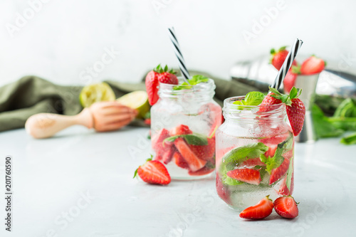 Alcohol cocktail mojito lemonade with rum, soda, strawberry and basil