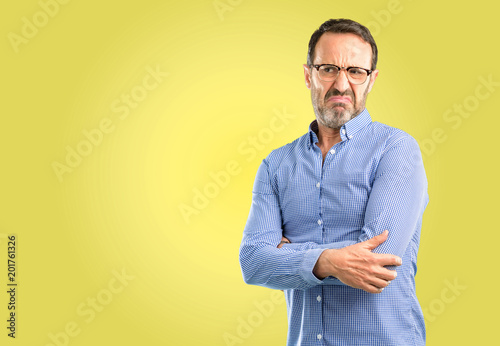 Handsome middle age man having skeptical and dissatisfied look expressing Distrust, skepticism and doubt