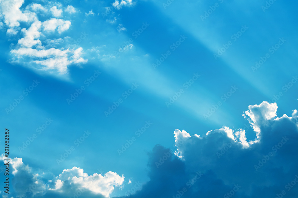 Background of a bright blue sky and blue clouds with sun rays. Bright abstract background ideal for any design. Main background for design Background of a bright blue sky and blue clouds with sun rays. Bright abstract background ideal for any design. Main background for design
