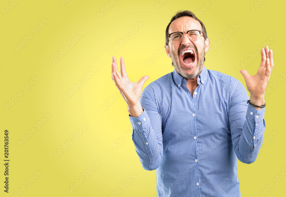 Handsome middle age man terrified and nervous expressing anxiety and panic gesture, overwhelmed Handsome middle age man terrified and nervous expressing anxiety and panic gesture, overwhelmed