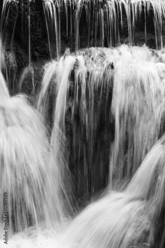 Full frame close-up of a cascade at the Tat Kuang Si Waterfalls near Luang Prabang in Laos. Natural abstract art in black and white.