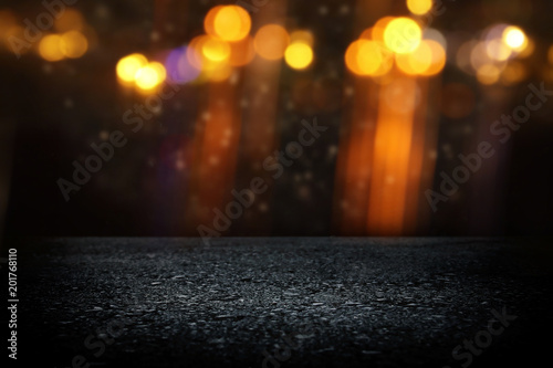 Spotlight on concrete floor. dark black and glowing lights