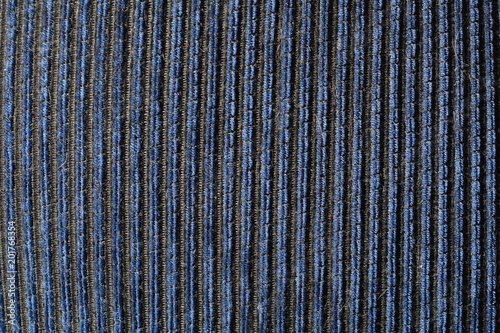 Textiles with vertical blue stripes. Volumetric  natural background. Light on the left.