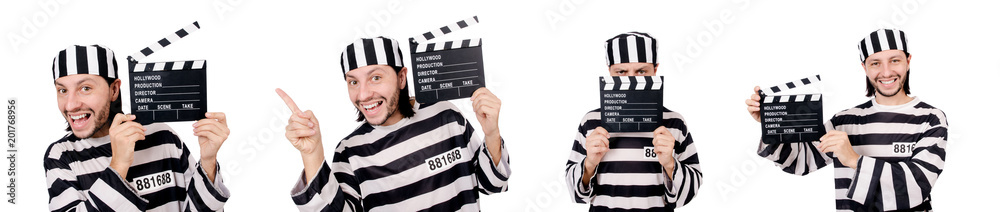 Funny prison inmate with movie board isolated on white Funny prison inmate with movie board isolated on white