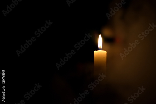 Candle in the dark. Smoke from a candle.