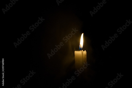Candle in the dark. Smoke from a candle.