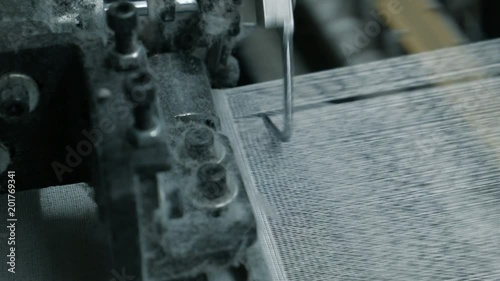 Сlose-up of the process fabric creation on a modern weaving loom in a factory
