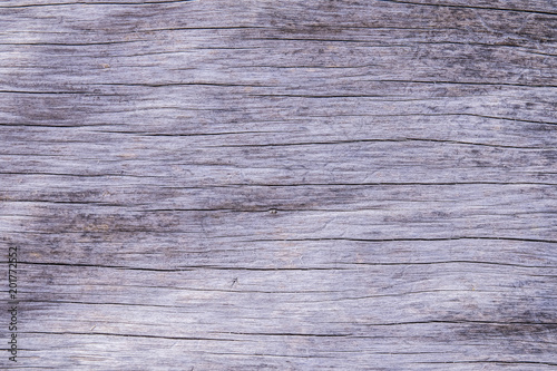 Organic dead wooden log with lines and cracks running horizontally to be used as a background