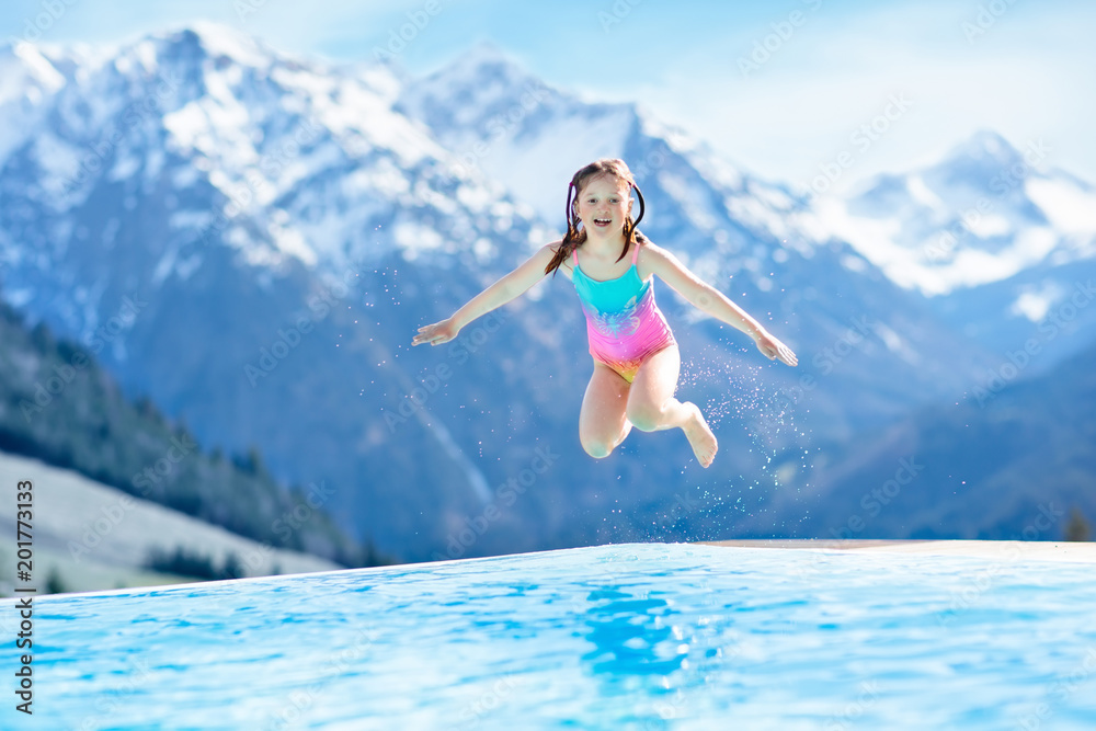 Child in outdoor swimming pool of alpine resort Child in outdoor swimming pool of alpine resort