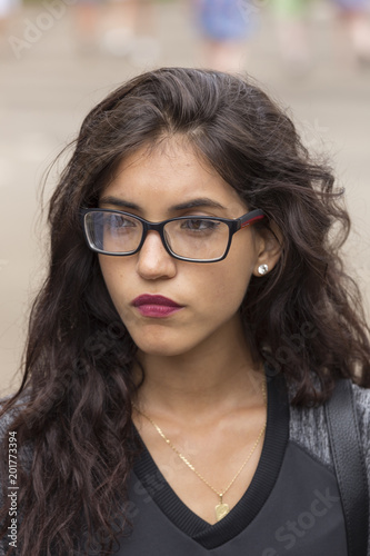 portrait of a brunette girl, with long hair and glasses