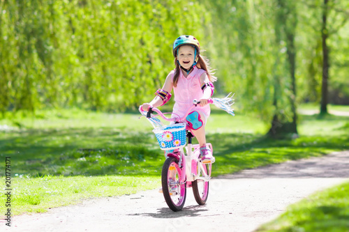 Fototapeta Naklejka Na Ścianę i Meble -  Child on bike. Kids ride bicycle. Girl cycling.
