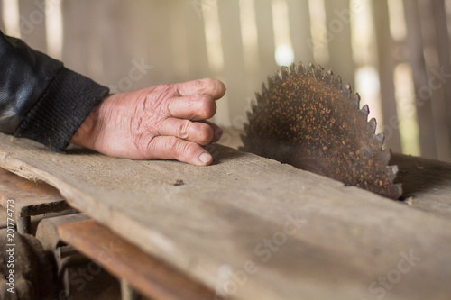 close-up of hand hand with cut-off fingers against the background of a circular saw. Injury and disability in the workplace