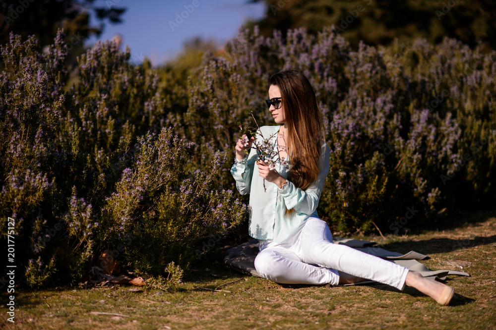 Beautiful girl with flowers in hands outdoors Beautiful girl with flowers in hands outdoors