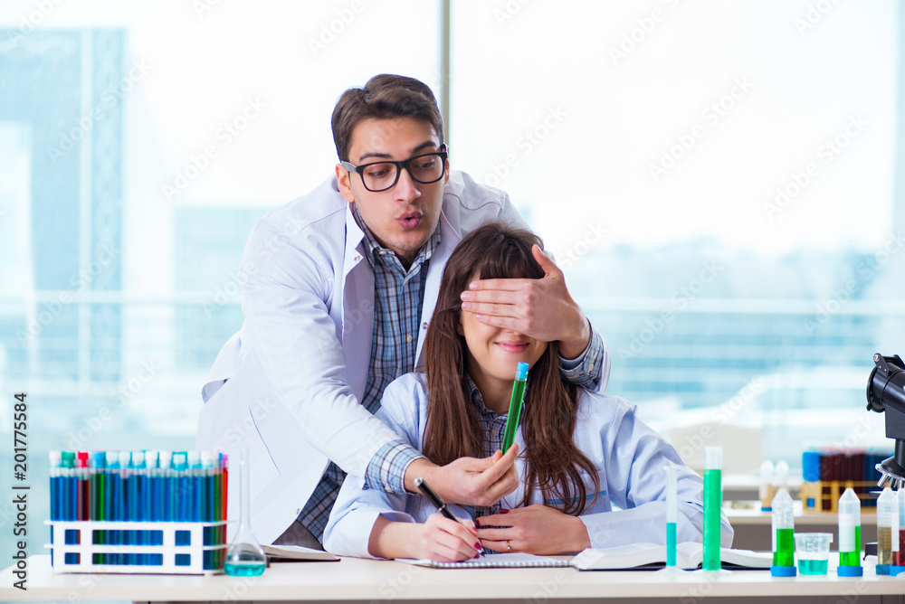 Obraz premium Two chemists working in lab experimenting