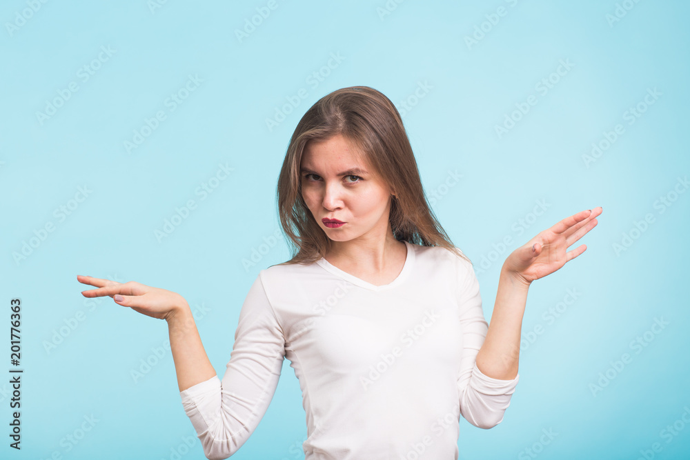 Energy girl dances on blue background in studio.