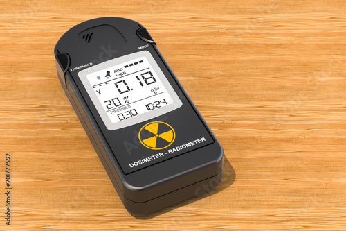 Gamma Radiation Personal Dosimeter on the wooden table, 3D rendering