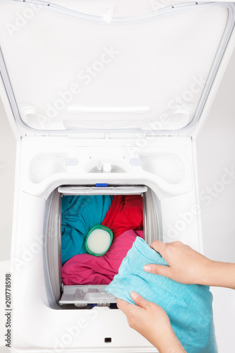 Washing machine loaded with clothes.