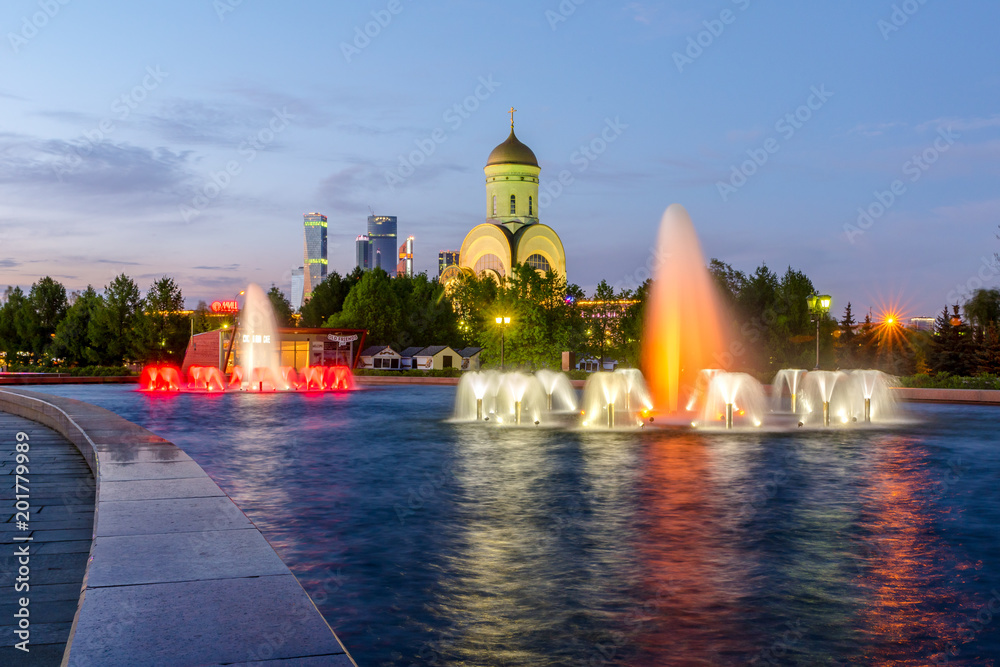 Fototapeta premium Fountains on Poklonnaya hill in victory Park. Church of St. George the victorious on Poklonnaya hill . Moscow. Russia. 