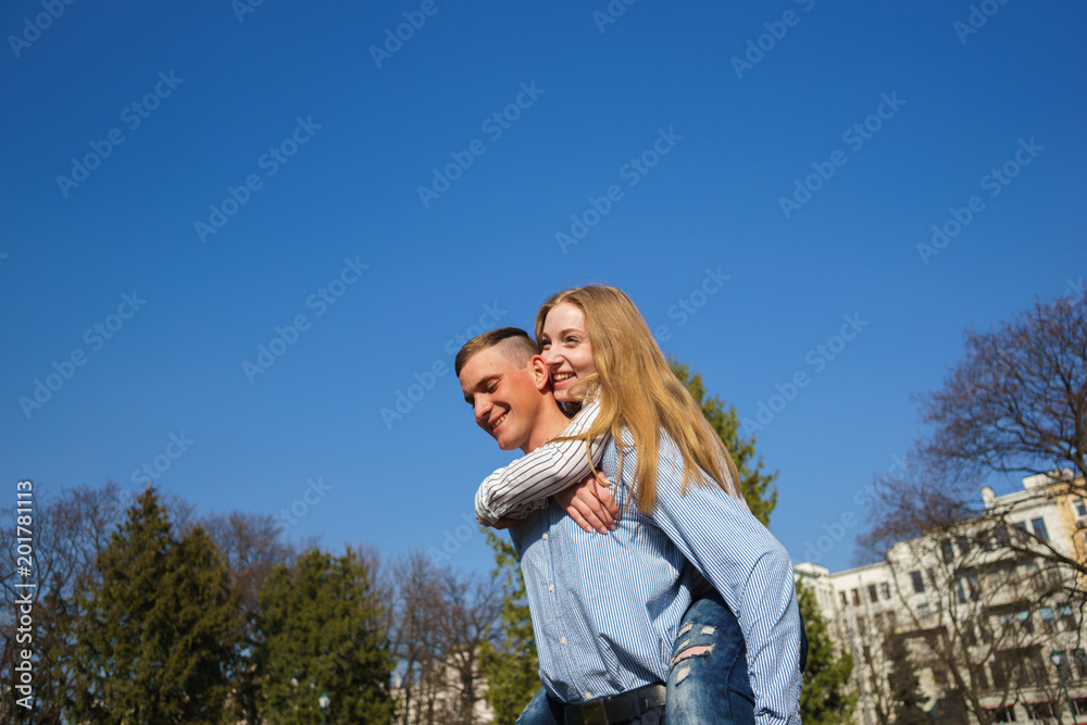 Couple hugging having fun outdoors, copy space