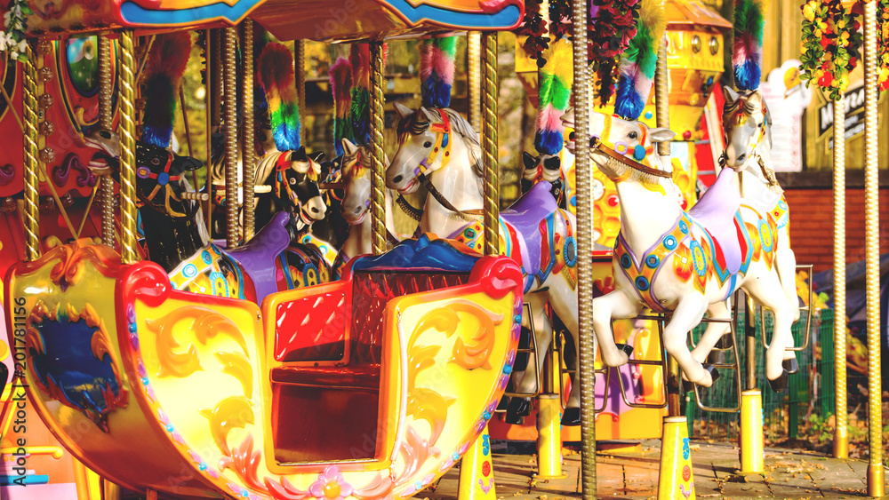 horses on a carousel in an amusement park, toned