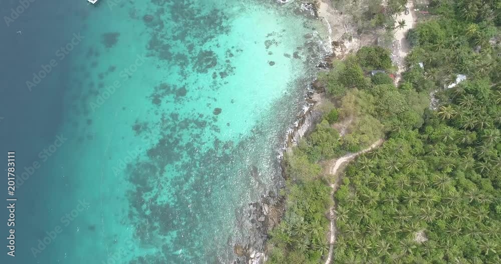 Aerial drone view of tropical landscape with palm trees and sea with boats Aerial drone view of tropical landscape with palm trees and sea with boats