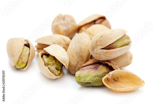 heap of roasted and salted pistachio isolated on white background