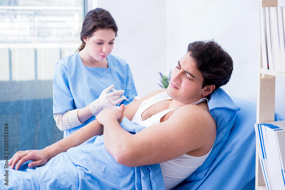 Doctor doing medical injection in hospital room Doctor doing medical injection in hospital room