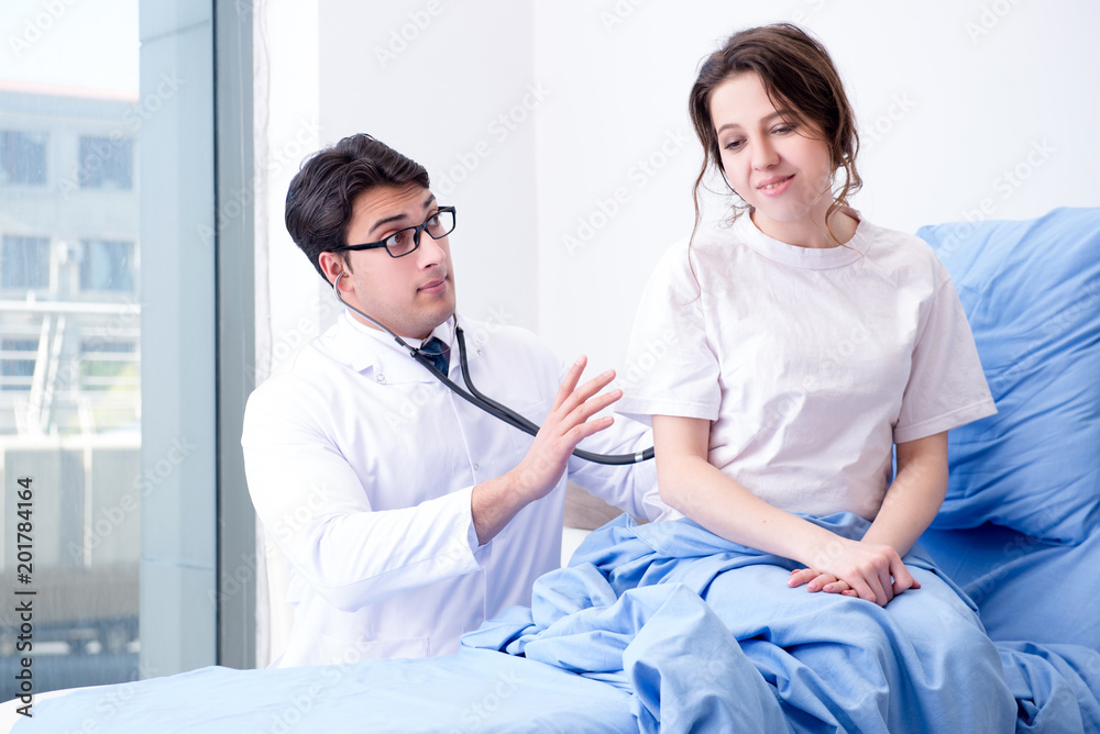 Fototapeta premium Doctor visiting patient in hospital room