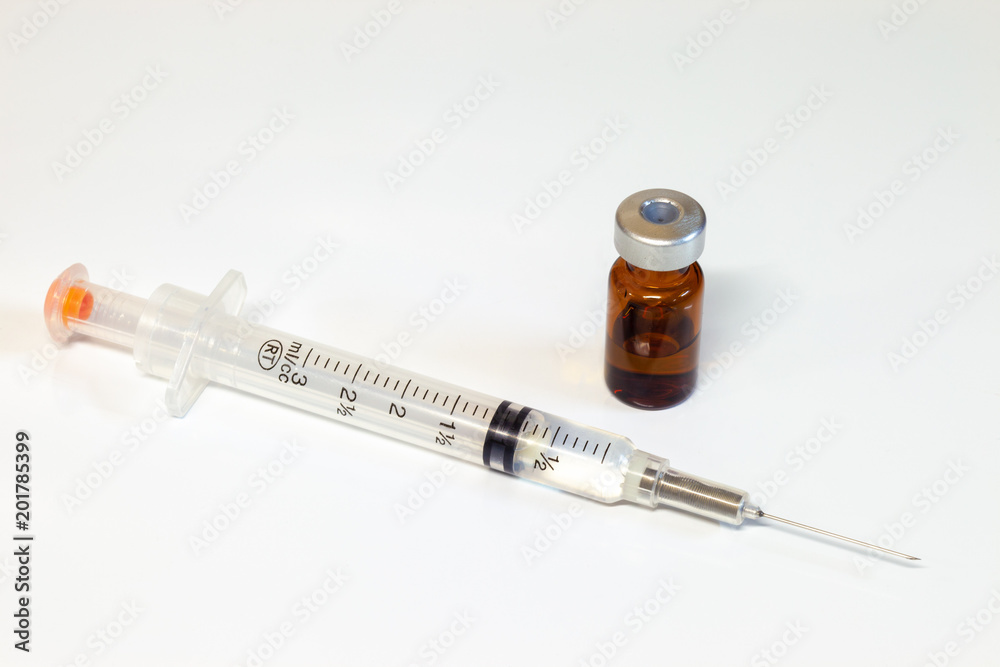 Medical Syringe and a vial of an intravenous drug on a white background Medical Syringe and a vial of an intravenous drug on a white background