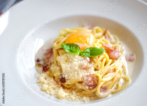 pasta carbonara with bacon and eggs on white plate 