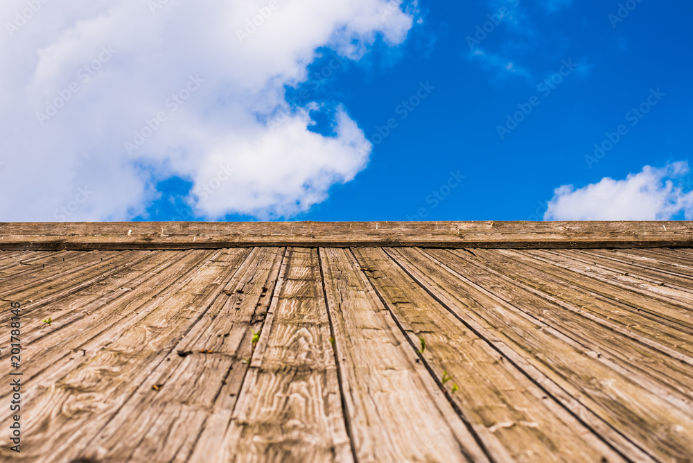 wooden roof and blue sky with clouds - copy space, background