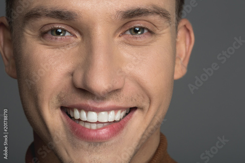Close up of male expression laughing while staring at camera. Isolated on background