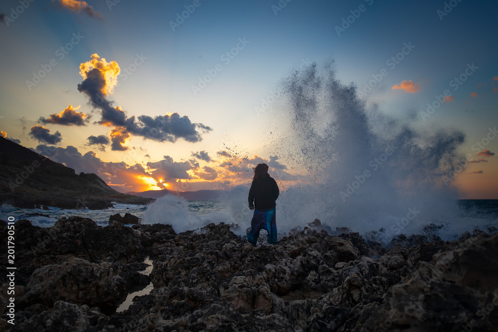Fototapeta Strong woman at a stormy sea. Sunset over Mediterranean. Facing your fears