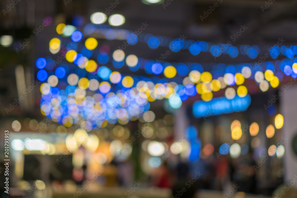 Multicolored defocused bokeh blurry lights. Abstract blur of red bokeh lighting for festival and celebration. Bokeh of light blub restaurants in shopping malls blurred background