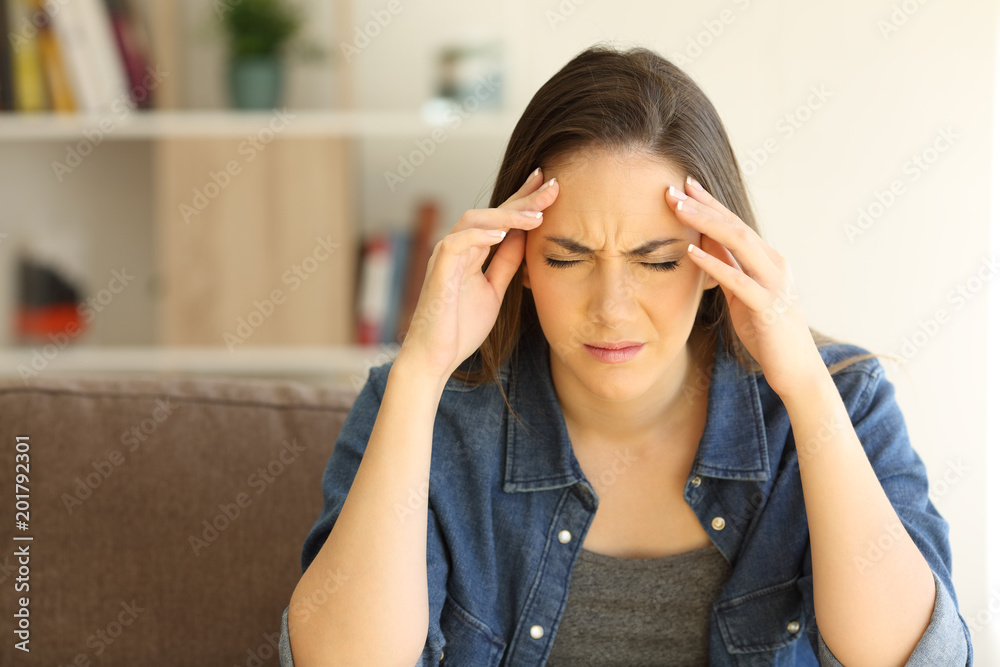 Woman complaining suffering migraine at home Woman complaining suffering migraine at home