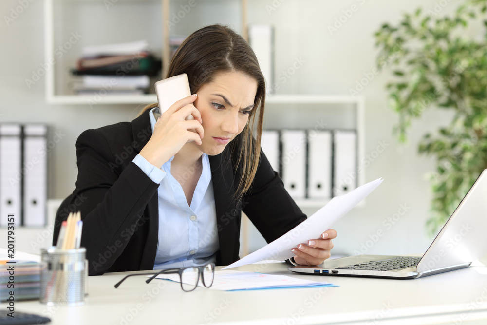Angry executive calling on phone at office Angry executive calling on phone at office