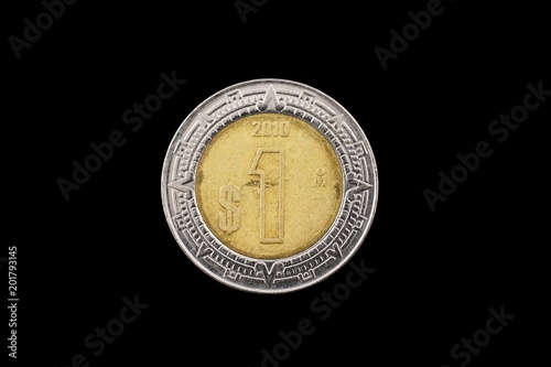 A macro image of a Mexican one peso isolated on a black background