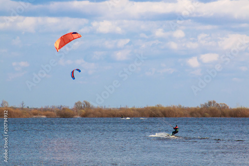 kitesurfing in the flooded meadows during the high water on a bright sunny day.