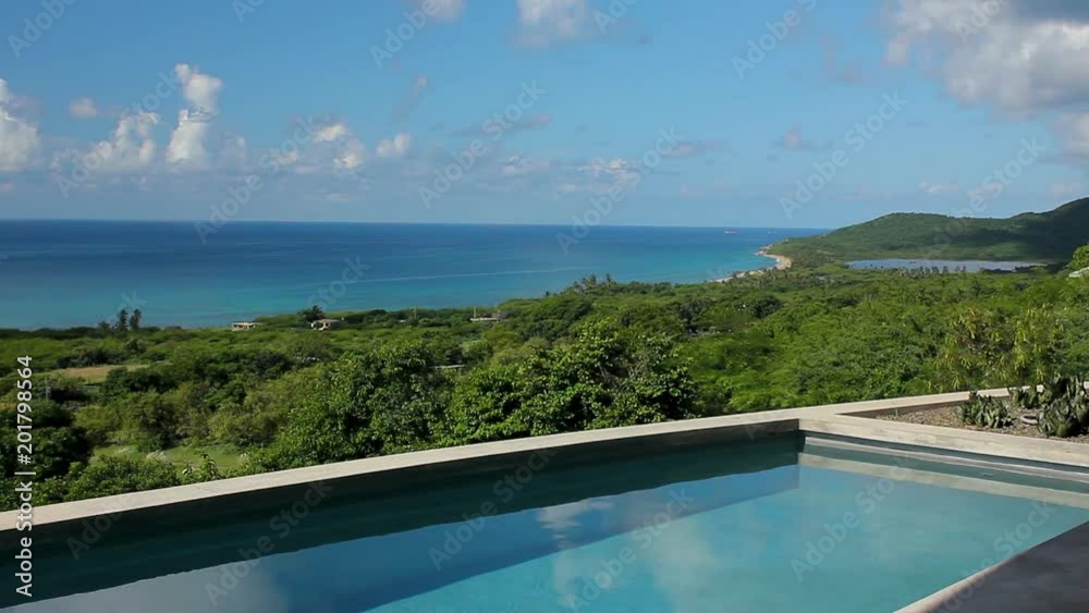 Clouds reflected in pool with unspoiled view of Caribbean Sea Clouds reflected in pool with unspoiled view of Caribbean Sea