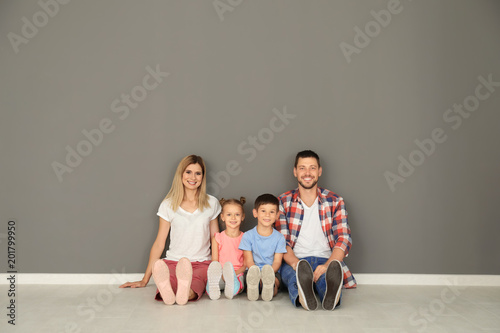 Happy family sitting on flo...